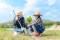 Asian Mom and child girl plant sapling tree in the nature spring for reduce global warming growth feature, Royalty Free Stock Photo